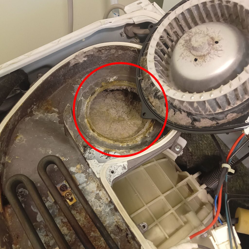 A WD8560F1 washer dryer combo with the top removed and clogged with lint